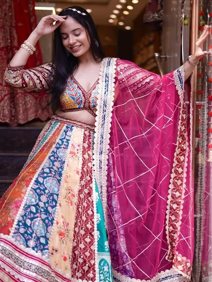 Wearing art, wearing tradition. This multi-colored lehenga is a kaleidoscope of beauty, perfect for a fun and festive wedding event.