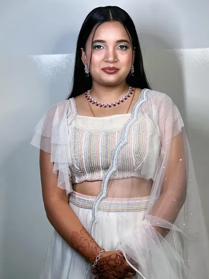 A full view of Dhanyatha's reception outfit. The makeup is light and fresh, with the focus on her eyes, making it perfect for a party atmosphere.
