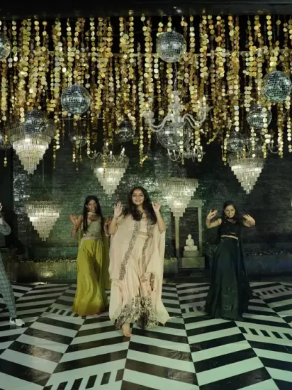 The bride's squad takes over the dance floor, performing under the glamorous ceiling of disco balls and chandeliers.