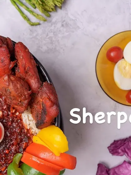 A closer look at the components of our Sherpa Rice, highlighting the tender grilled chicken pieces, hard-boiled eggs, and the rich gravy that brings the entire dish together.