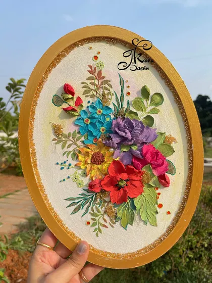A 12-inch oval wall panel featuring a vibrant bouquet of flowers in shades of red, purple, blue, and yellow.