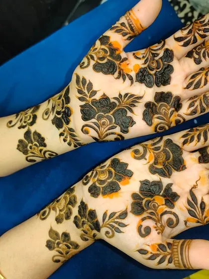 A similar floral design, showing the beautiful contrast between the dark henna and the skin.