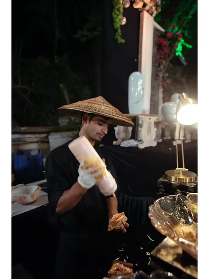 A member of my team dressed in theme-appropriate attire for a Pan-Asian station, showcasing how we adapt our presentation to fit the event's concept.