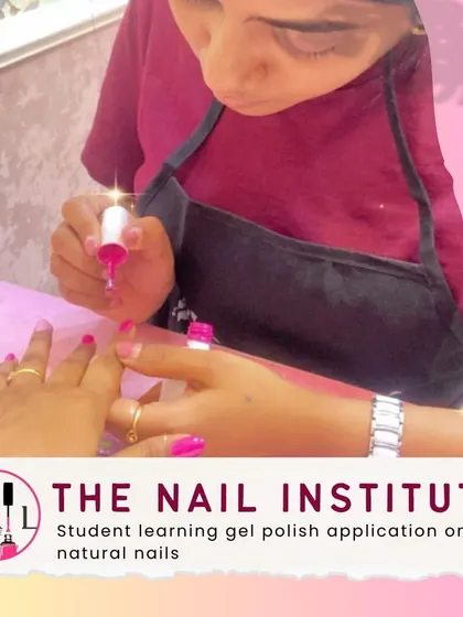 A student practices applying gel polish on natural nails, focusing on achieving a smooth, even coat without flooding the cuticles.