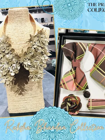 This coordinated gift set includes a men's accessory box with a brown and pink plaid bow tie and tie. It is paired with a detachable collar for women, featuring intricate beige 3D floral details.