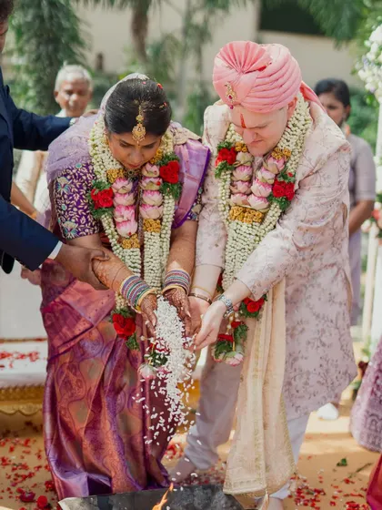 Two cultures uniting in a single, sacred ritual. This shot captures the couple participating in a traditional Hindu ceremony, a beautiful symbol of their shared journey.