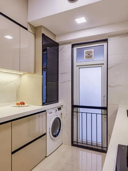 The utility area of the parallel kitchen, with a dedicated space for the washing machine.