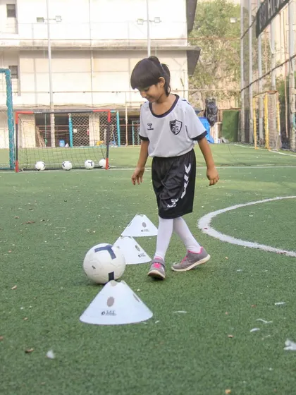 A moment of concentration during a simple cone exercise. We believe in giving every child the help and hope they need to believe in their own abilities.
