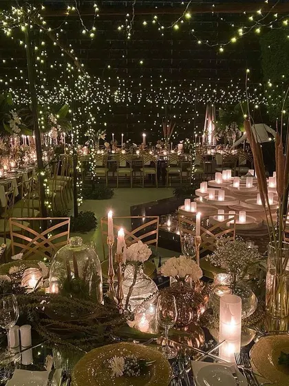 Another view of the whimsical "starry night" dining setup. This perspective shows the layers of detail, from the candlelit tablescapes to the expansive ceiling of fairy lights that covers the entire space.