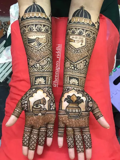 A full and intricate bridal design. This piece combines traditional elements like the dhol and kalash with personalized dates, all tied together with beautiful floral and geometric patterns.