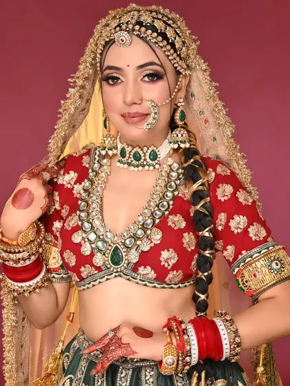 This image showcases the full bridal attire, with the makeup acting as the perfect anchor for the heavy jewelry and colourful lehenga.