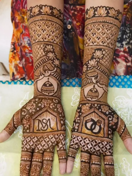 Engagement bells are ringing with this beautiful design. It features the couple's initials, engagement rings, and a doli, symbolizing the bride's journey to her new home.