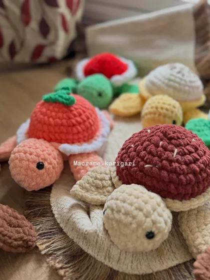 A group of our chunky yarn turtles piled together. This shot shows the variety of colors and textures we use. They are perfect for starting a collection or gifting to a fellow turtle lover.