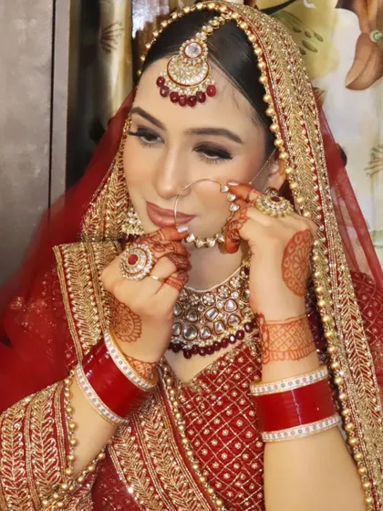 A playful pose with the nath, showing the bride's personality and the beautiful makeup.