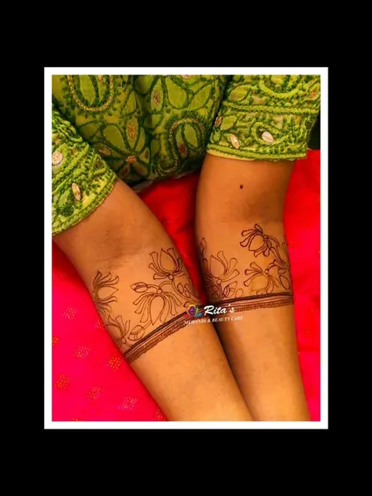 A beautiful and modern lotus armband design. This style is perfect for guests at a wedding or for festive occasions, showing the versatility of henna beyond traditional hand designs.