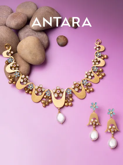 My lightweight 22kt matte gold collection is for those who move differently. This necklace and earring set, inspired by blooming waves and wildflowers, blends textures and luminous pearls into wearable art that is bold yet feels featherlight.