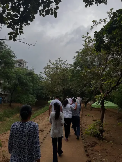 Volunteers walk along a path at Aravali Creek, where 200 new native saplings were just planted by the Calpro Specialities team.