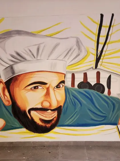 A close-up of the chef and his animated chili and broccoli characters, adding a touch of humor to the artwork.