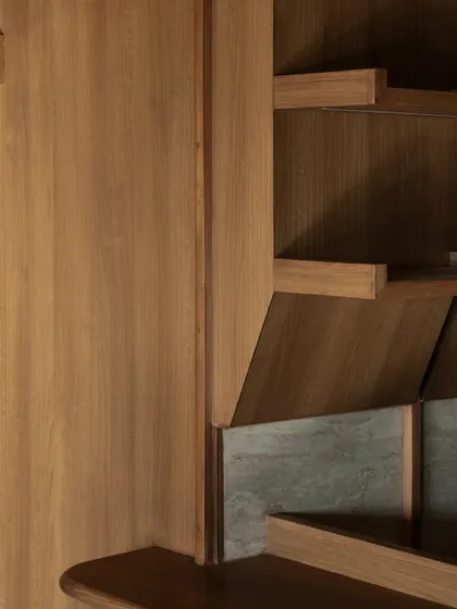 Details of the custom joinery and shelving at QBF Coffee. The design language is one of honest craftsmanship, with exposed brackets and a mix of wood and stone textures.