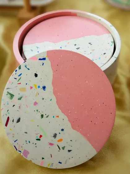 A set of four terrazzo coasters with a matching holder. This is a great option for a more substantial return gift or a housewarming present. The colors and shapes can be customized.