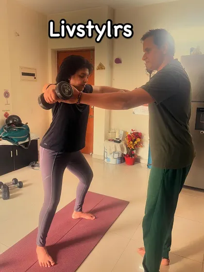 I am guiding a client through a squat variation with dumbbells, ensuring her form is correct to maximize results and prevent injury.