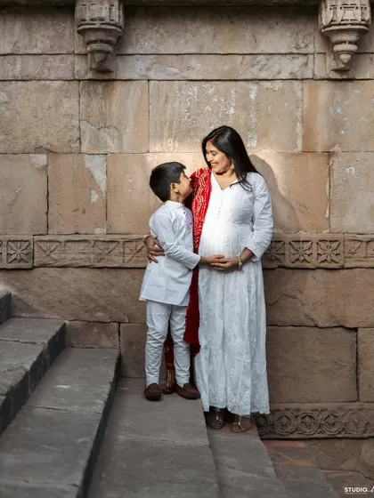 The sweetest conversations are with the one you haven't met yet. A mother and son sharing a moment of anticipation for the new baby.