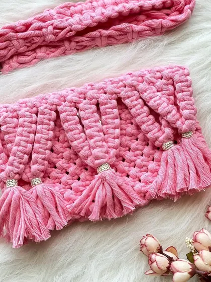 A playful and feminine design, this pink sling bag features beautiful cascading tassels, each accented with a small bead for a touch of sparkle.