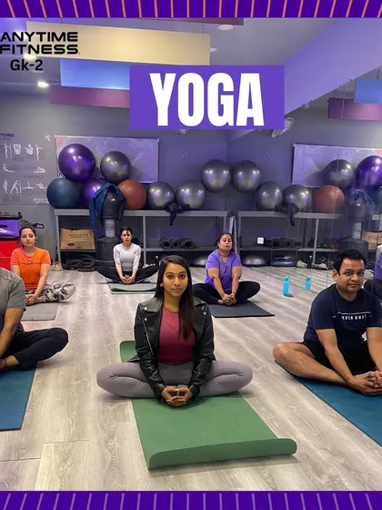 A serene moment from our yoga class. Members are seated in a meditative pose, finding their center. This image perfectly captures the calm and focus of our yoga sessions.