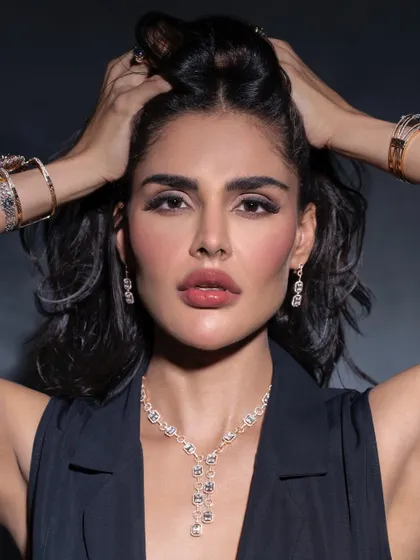 A strong and confident pose from the same diamond jewellery campaign. The focus here is on the model's direct gaze and the way the light catches the stunning diamond pieces.
