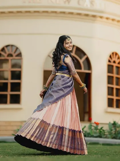 A happy twirl from bride Brunda in her custom half saree. The movement of the pleated Kanjivaram skirt is just beautiful.
