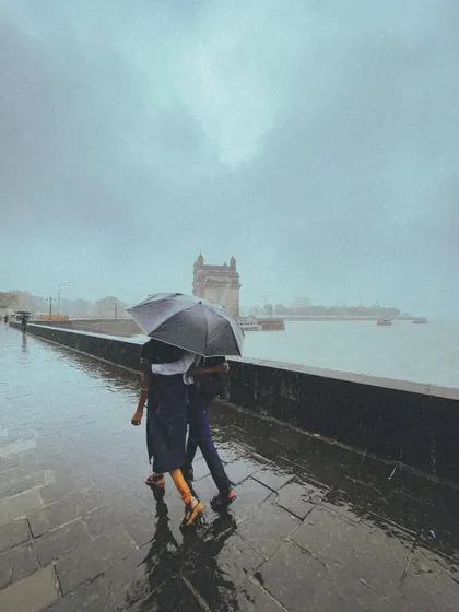 A quiet moment for a couple sharing an umbrella, with the iconic Gateway of India standing softly in the monsoon mist. This is the kind of love story I live to capture, simple and profound.