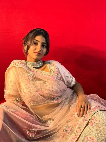 A modern and chic pastel pink lehenga with delicate floral embroidery. This outfit is perfect for a daytime wedding or an engagement ceremony.