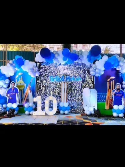 A perfect birthday party for a young cricket fan. This outdoor setup features a blue and white balloon arch, a sequin backdrop, and life-size cutouts of famous Indian cricketers.