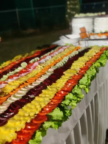 A beautifully arranged salad bar, showcasing our commitment to freshness and presentation. We offer a variety of fresh vegetables, fruits, and dressings.