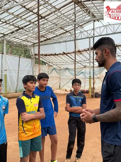 A close-up of Aman Khan mentoring a small group of our junior players. These intimate interactions are incredibly valuable for their growth and confidence.