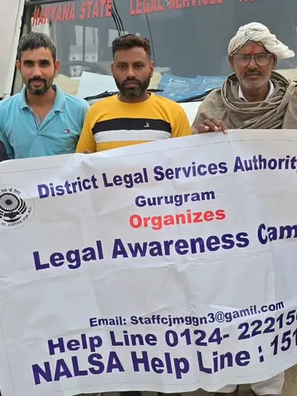 With local residents during a DLSA legal awareness campaign in a village. Holding our banner high, we bring information about free legal aid and helpline numbers directly to the people.