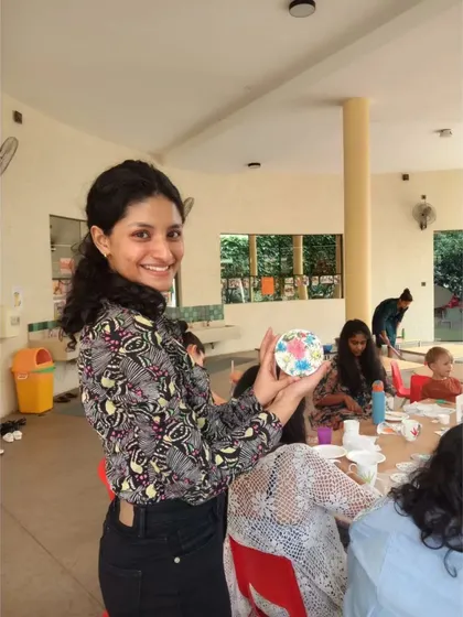 Showing off a finished piece in the middle of a busy workshop. It's always a joy to see a room full of people engaged in creating their own traditional mud and mirror art.