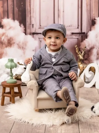 Dressed to impress for his first birthday! We style unique themed portraits like this "Little Gentleman" setup, complete with vintage-inspired props and outfits, to perfectly capture your baby's budding personality.