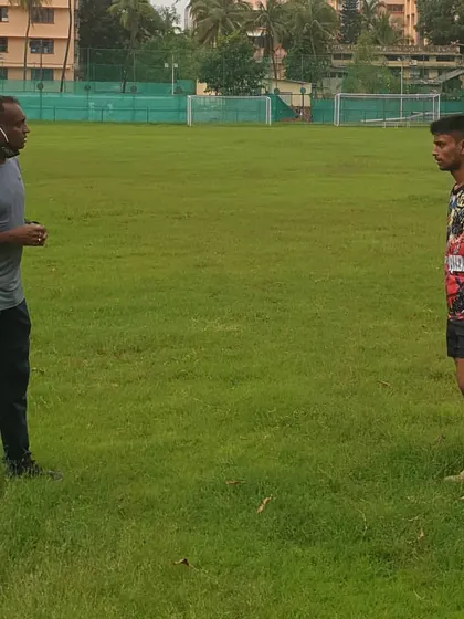 I believe in hands-on coaching. Here, I am providing post-workout feedback to an athlete, focusing on correcting form to maximize performance and prevent injuries.