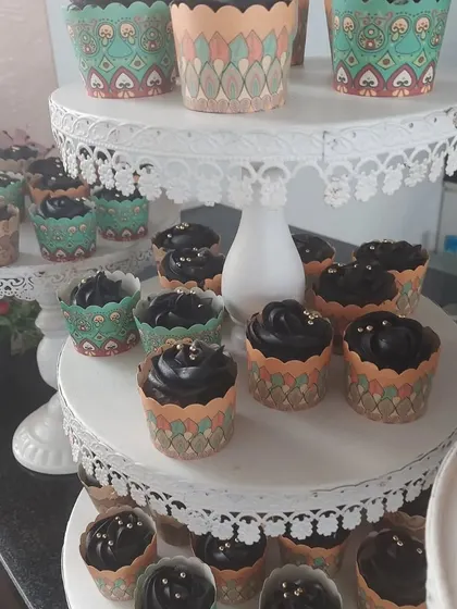 A beautiful display of chocolate cupcakes on tiered stands for a corporate event. Our presentation is designed to be as visually appealing as the food is delicious.