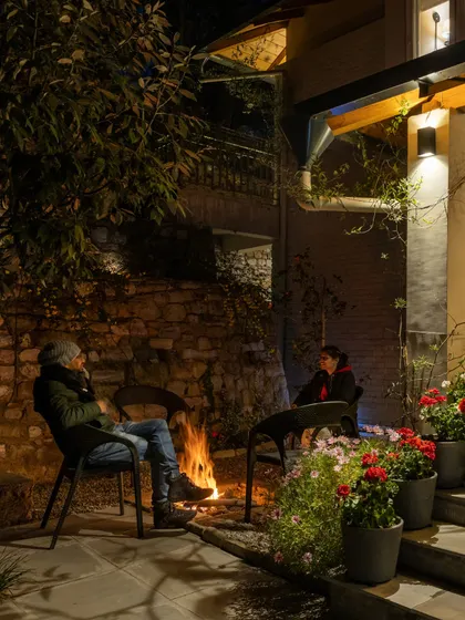 Guests enjoying a bonfire on a cool evening. Community and connection are just as important as the individual practice on my retreats.