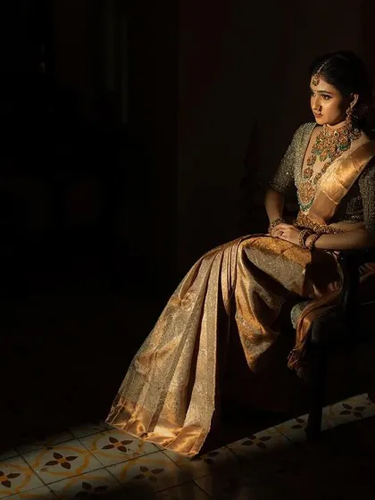 A dramatic portrait using a single sliver of light to illuminate the bride. This artistic choice creates a moody, elegant, and memorable image.