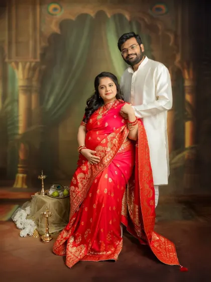A classic couple portrait that feels royal and timeless. Dressed in a beautiful red saree, you two look absolutely radiant. These traditional studio sessions are perfect for creating elegant keepsakes.