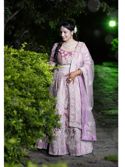 This was my own wedding reception look. I chose a soft, romantic makeup style with a half-up, half-down curly hairstyle to go with my sequined lehenga.