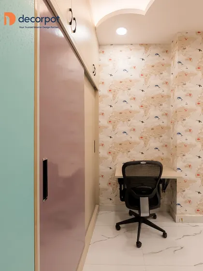 This compact study area is cleverly placed next to a sliding wardrobe. The world map wallpaper adds an educational and adventurous theme to this cozy corner.