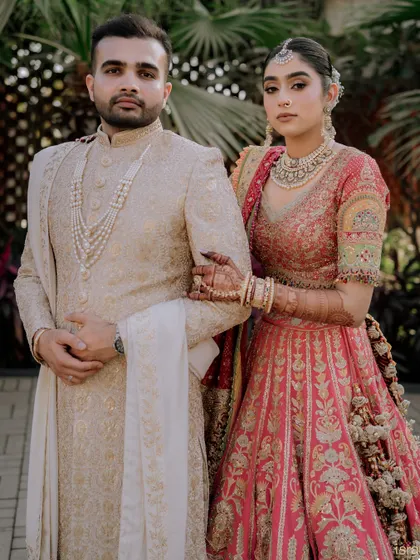 A powerful and poised portrait of the couple, ready to begin their life together. Their coordinated outfits and strong presence make for a striking image.