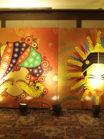 The pair of quirky, lighted bride and groom face installations, creating a unique and memorable photo opportunity for guests.
