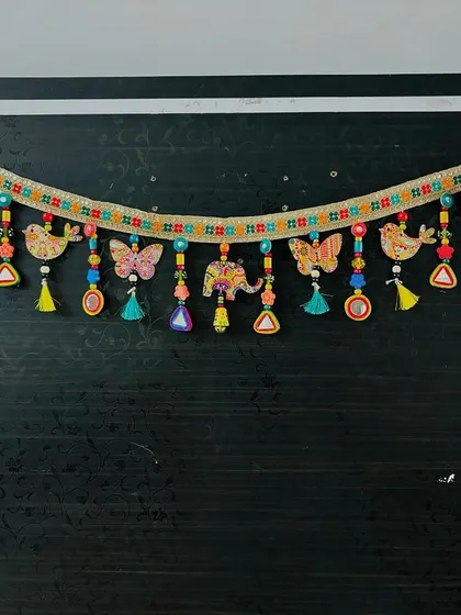 A wide shot of the 'Bageecha' Toran. This piece brings so much life and color to a doorway, welcoming everyone with its cheerful design.