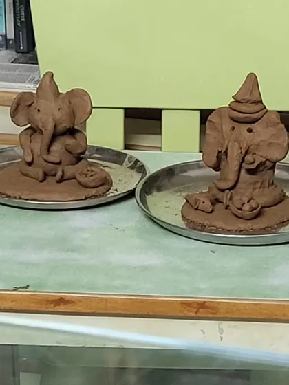 Two finished clay Ganeshas, each with its own unique personality. Our workshops celebrate individuality and creativity.