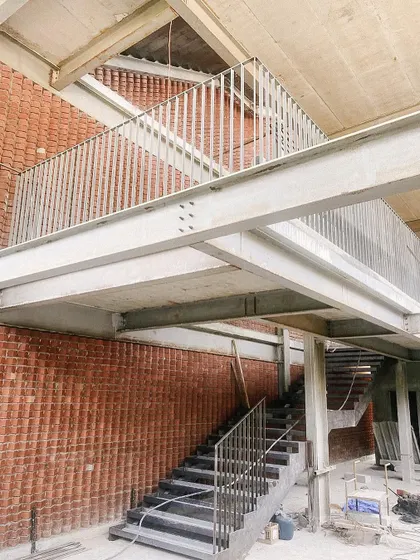 The steel framework of a staircase and mezzanine at the Play Arena project. This highlights my studio's expertise in steel buildings and creating layered, multi-level spaces.